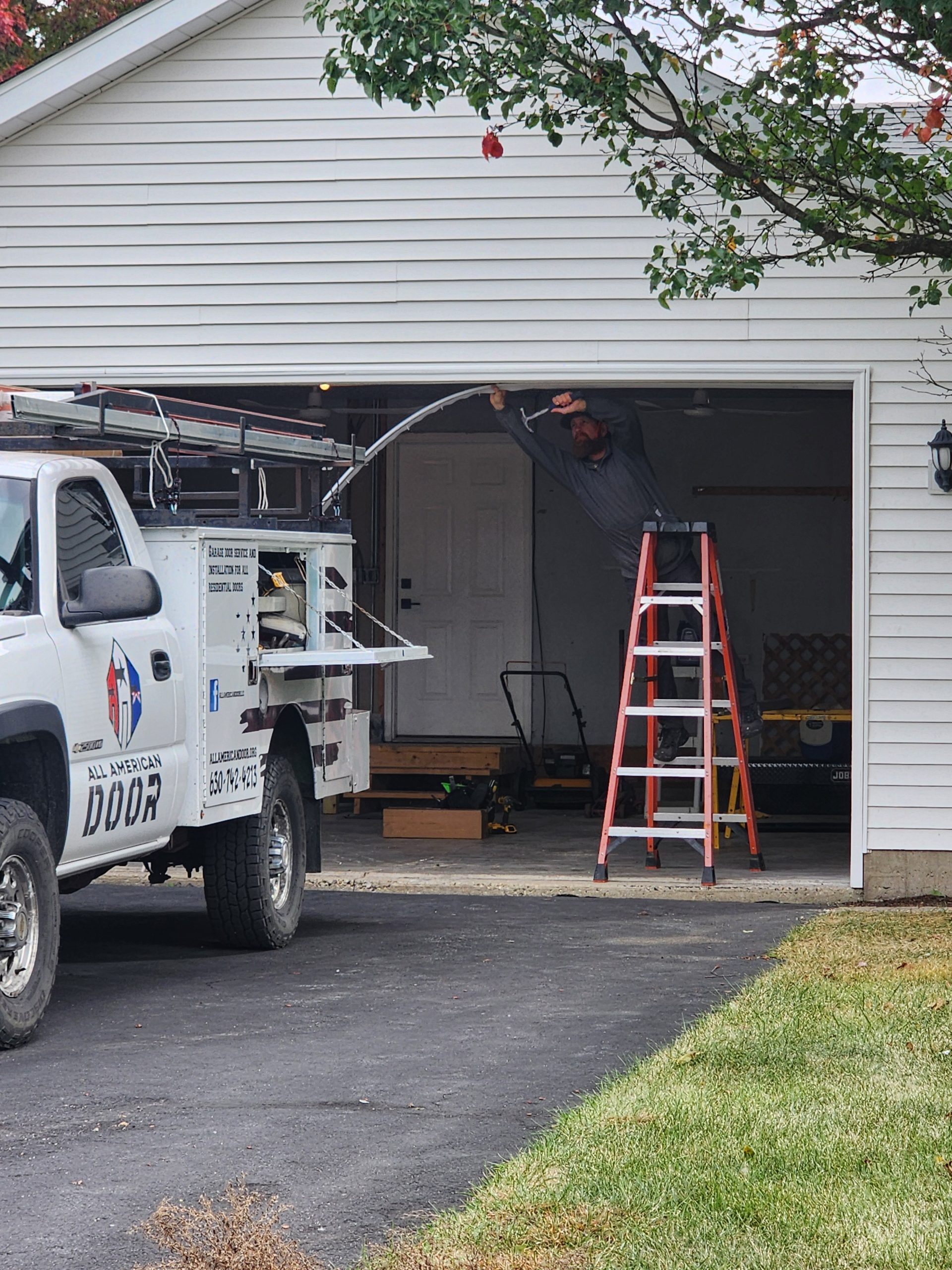 All American Door, LLC truck outside on a job site.