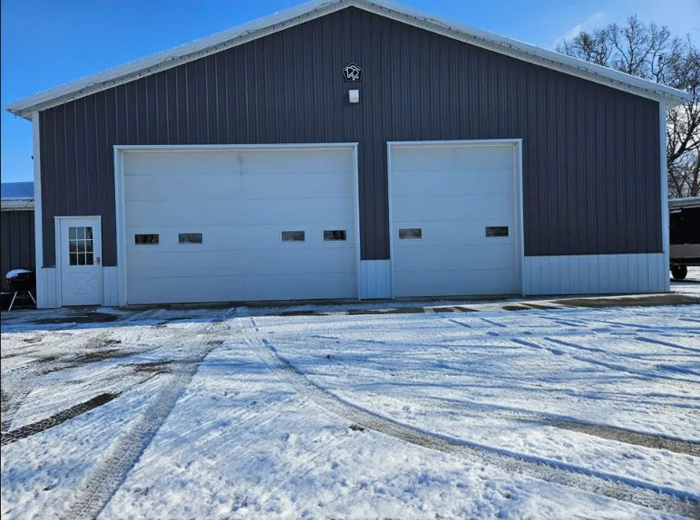 Two warehouse garage doors, one wider than the other.