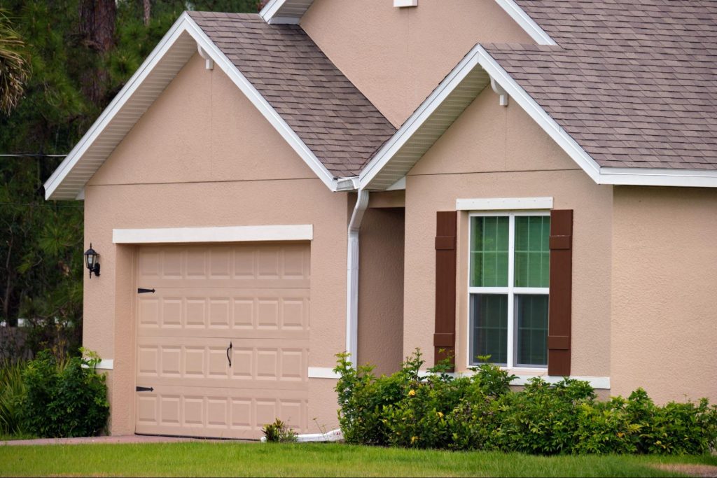 Residential home with a garage door and yard.